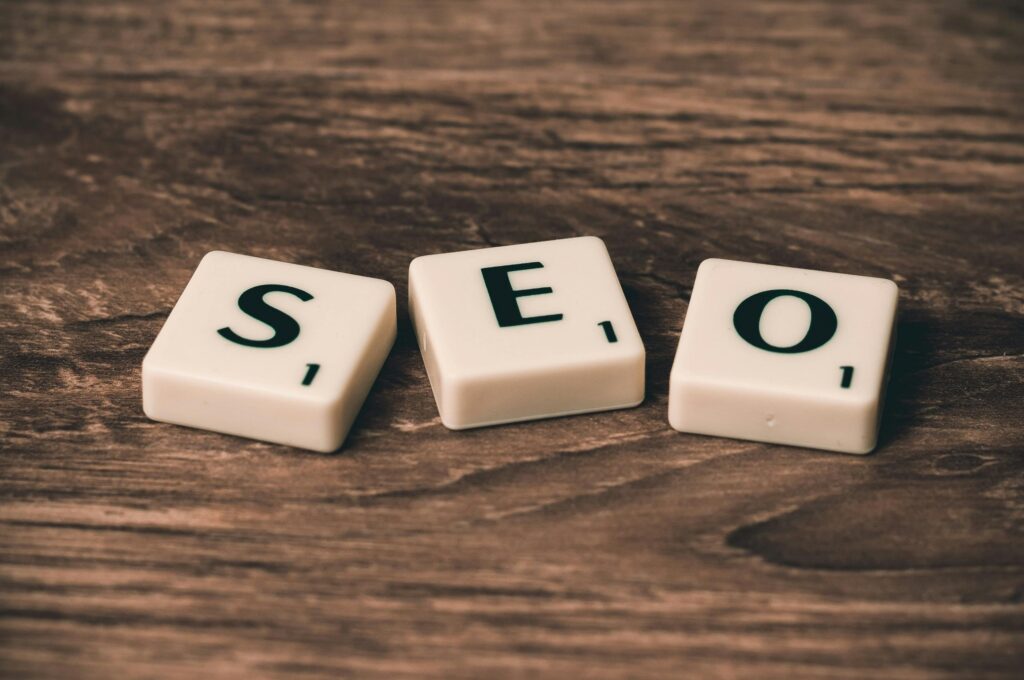 Scrabble tiles spelling 'SEO' on a wooden surface. Ideal for digital marketing themes. The word “SEO” on screen, symbolizing how you can stop being tired of chasing algorithms by letting search engines bring traffic to your site.