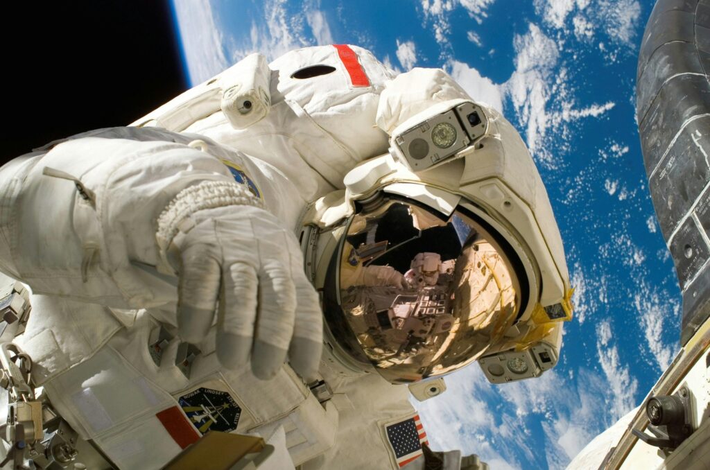 Astronaut floating in space during a spacewalk, visible Earth in the background. Planet Earth view with calming atmosphere โ perfect for a relaxing music video.